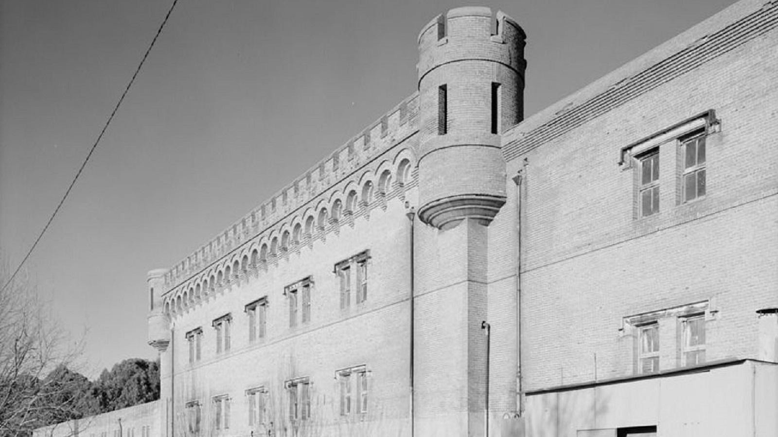 Black and white photo of brick building.