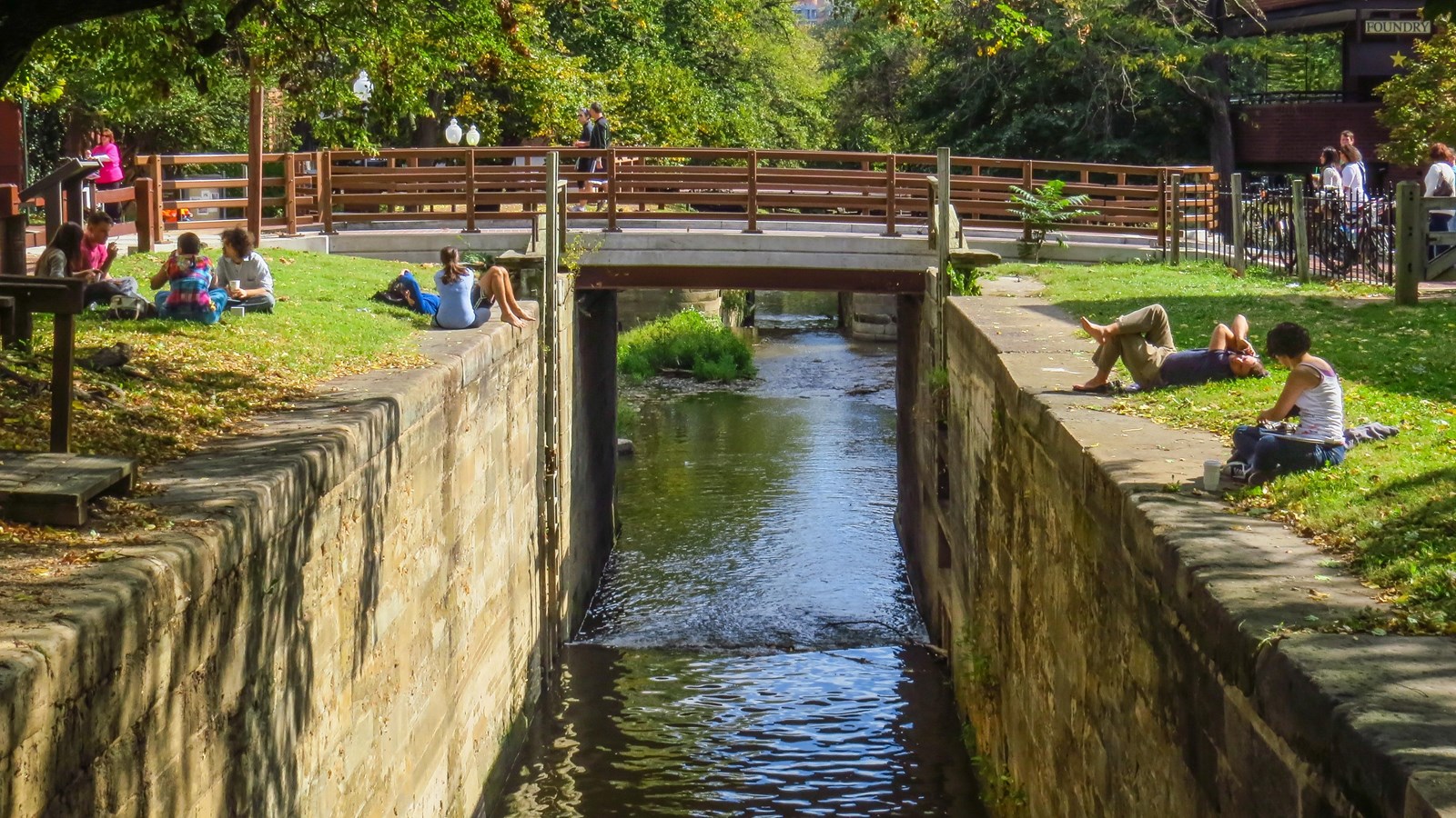 People sit on the sides of lock 4.
