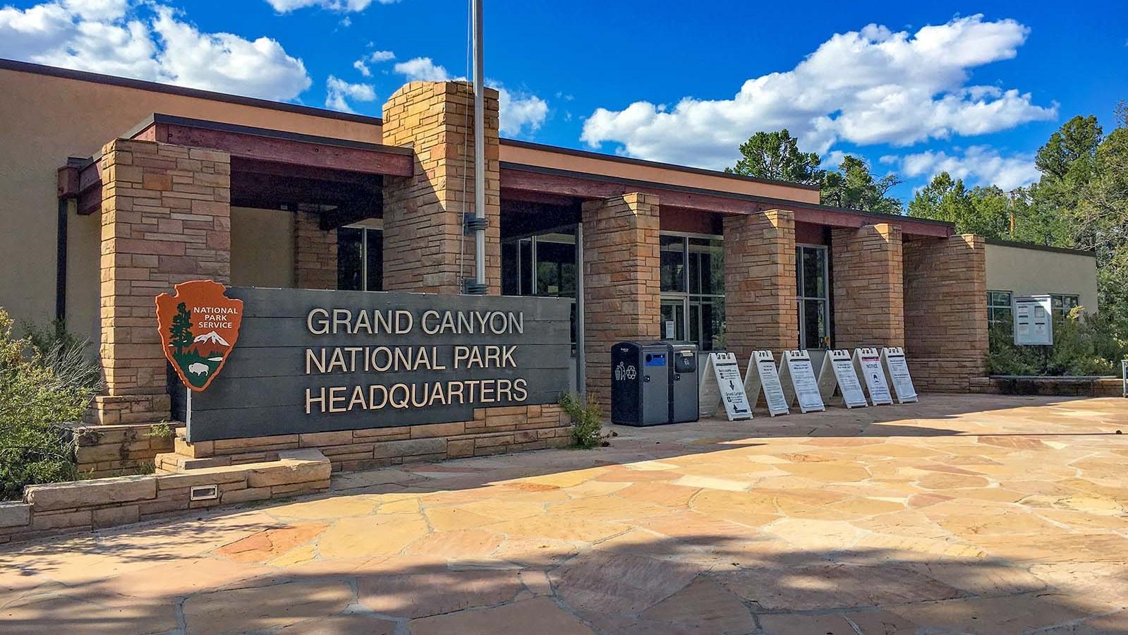 A large sign outside a wide single-story building reads