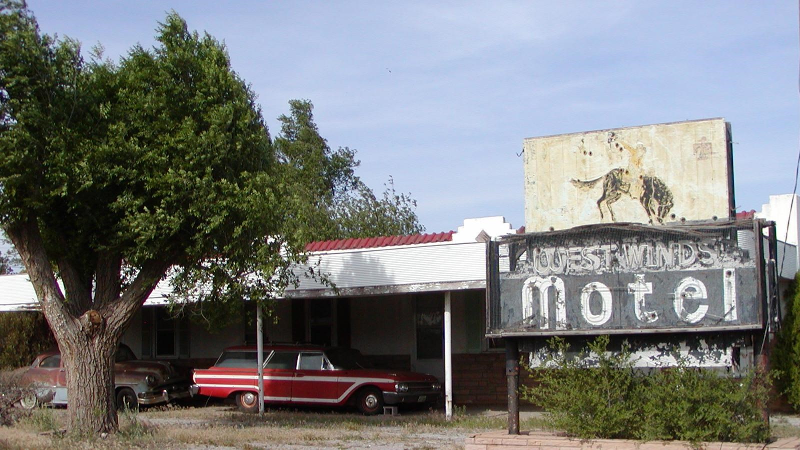 A faded sign with a bucking bronco reads