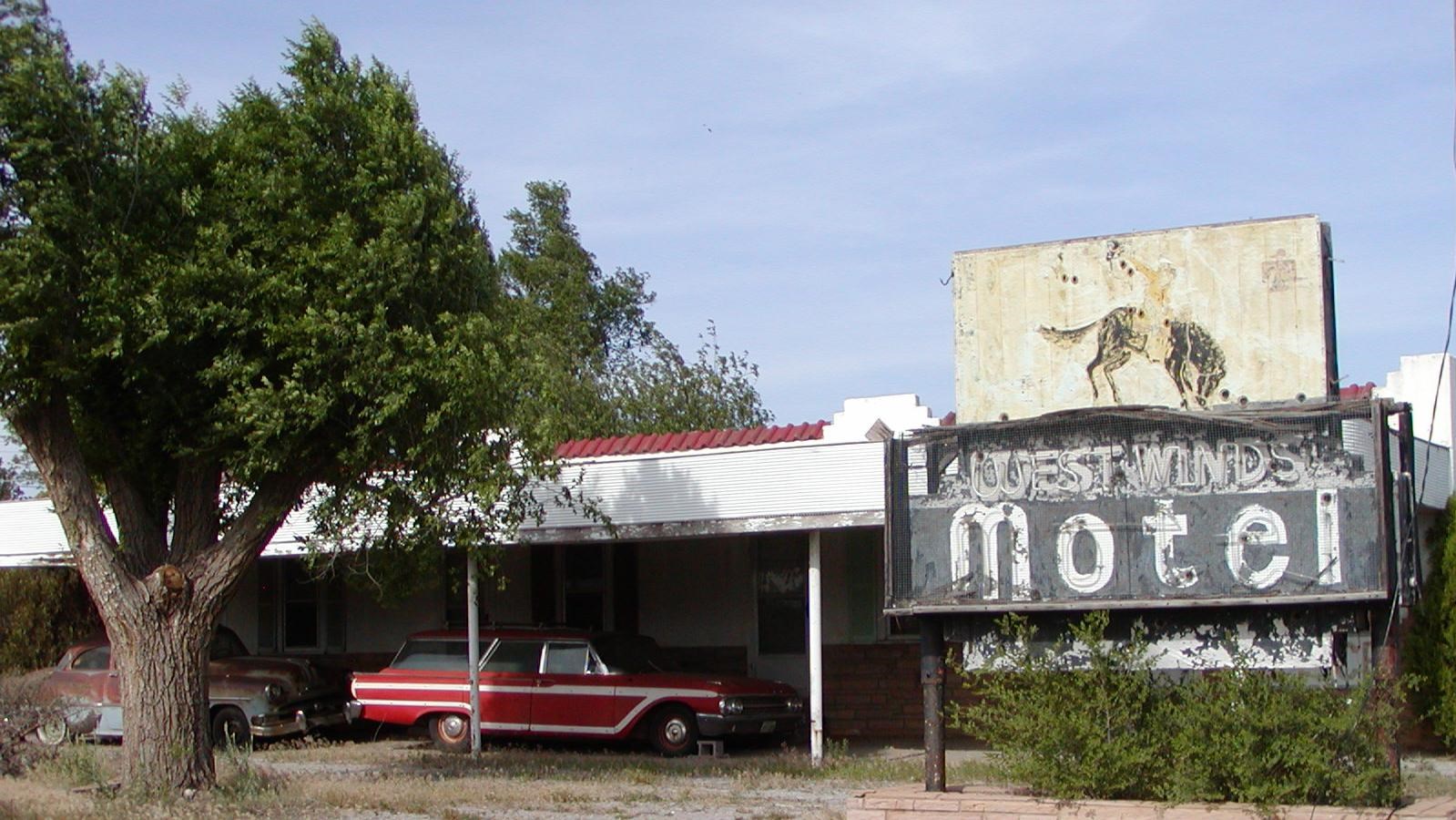 A faded sign with a bucking bronco reads 