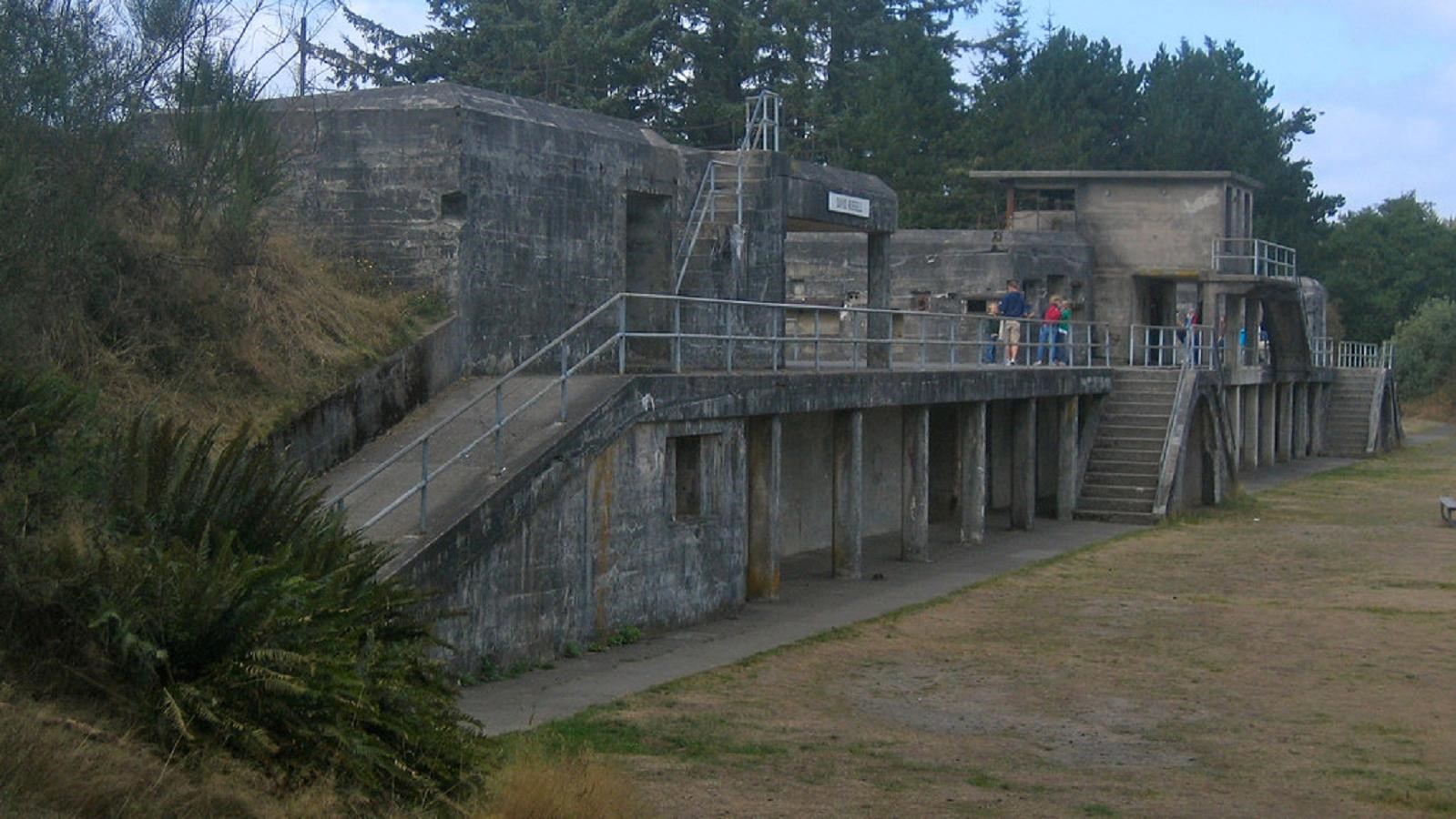 A turn of the century two story stone gun battlement with ramps and stairs.