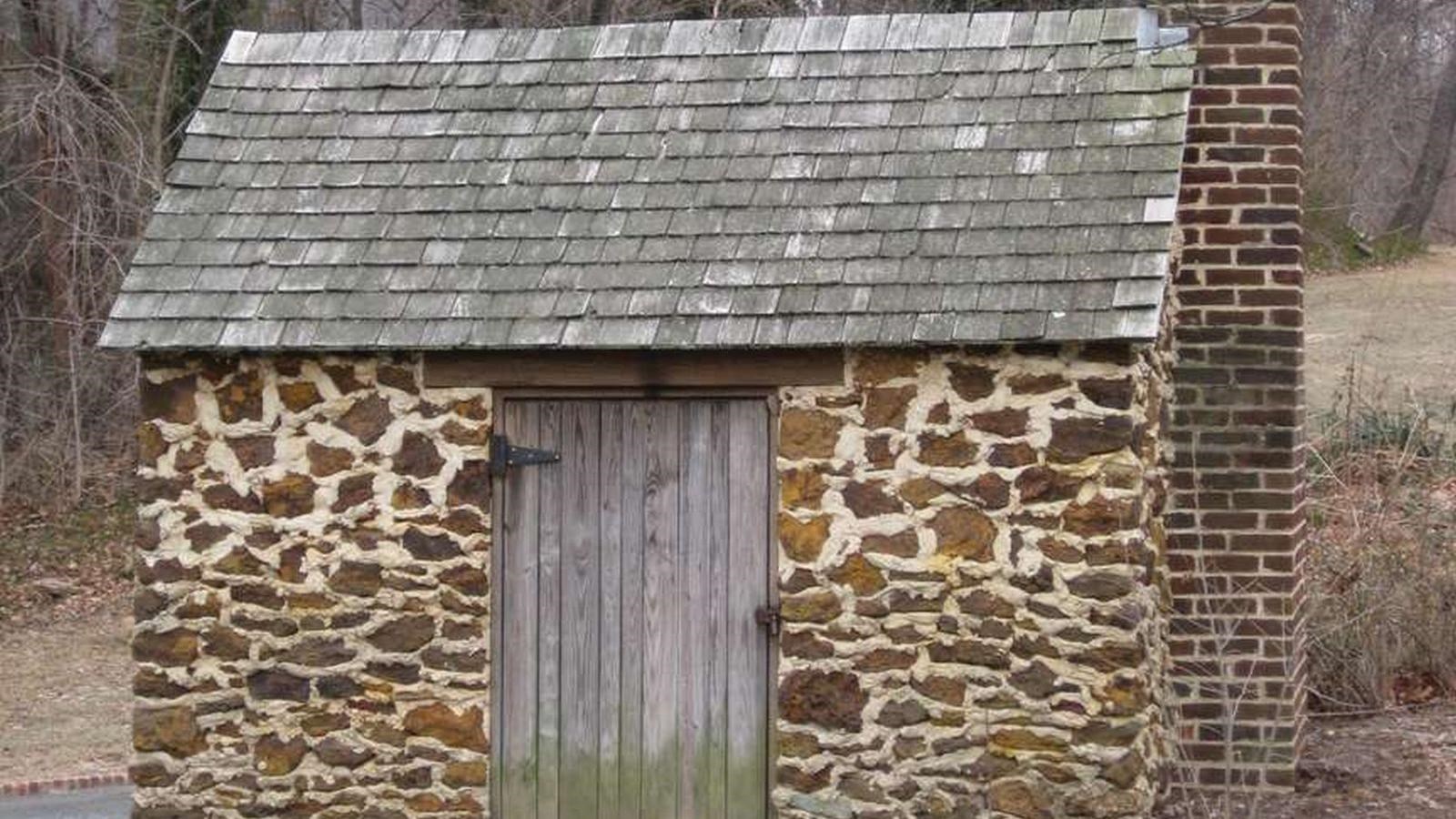 A tiny brick building with a chimney