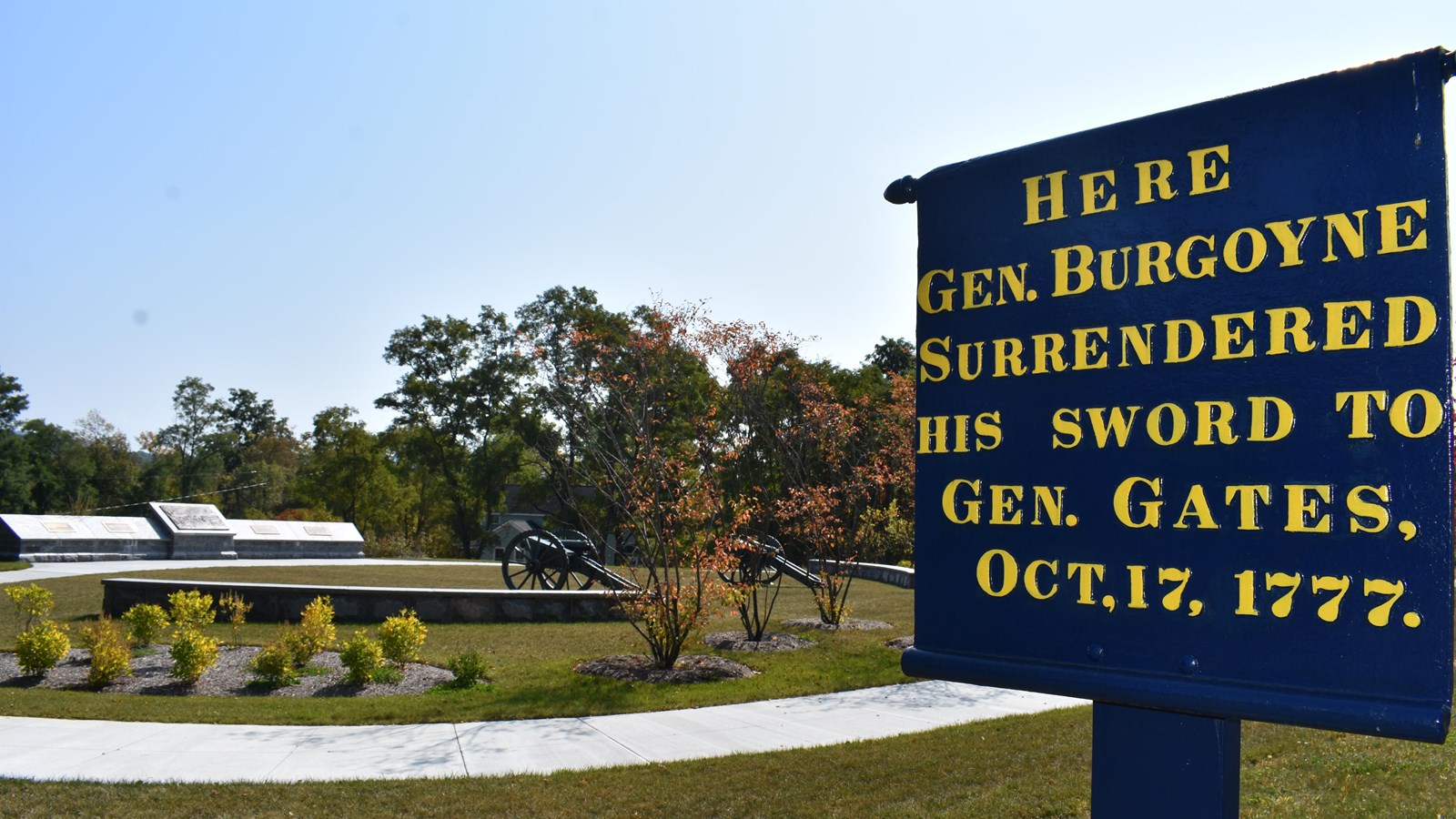 sign describing place of surrender in foreground, memorial park in background