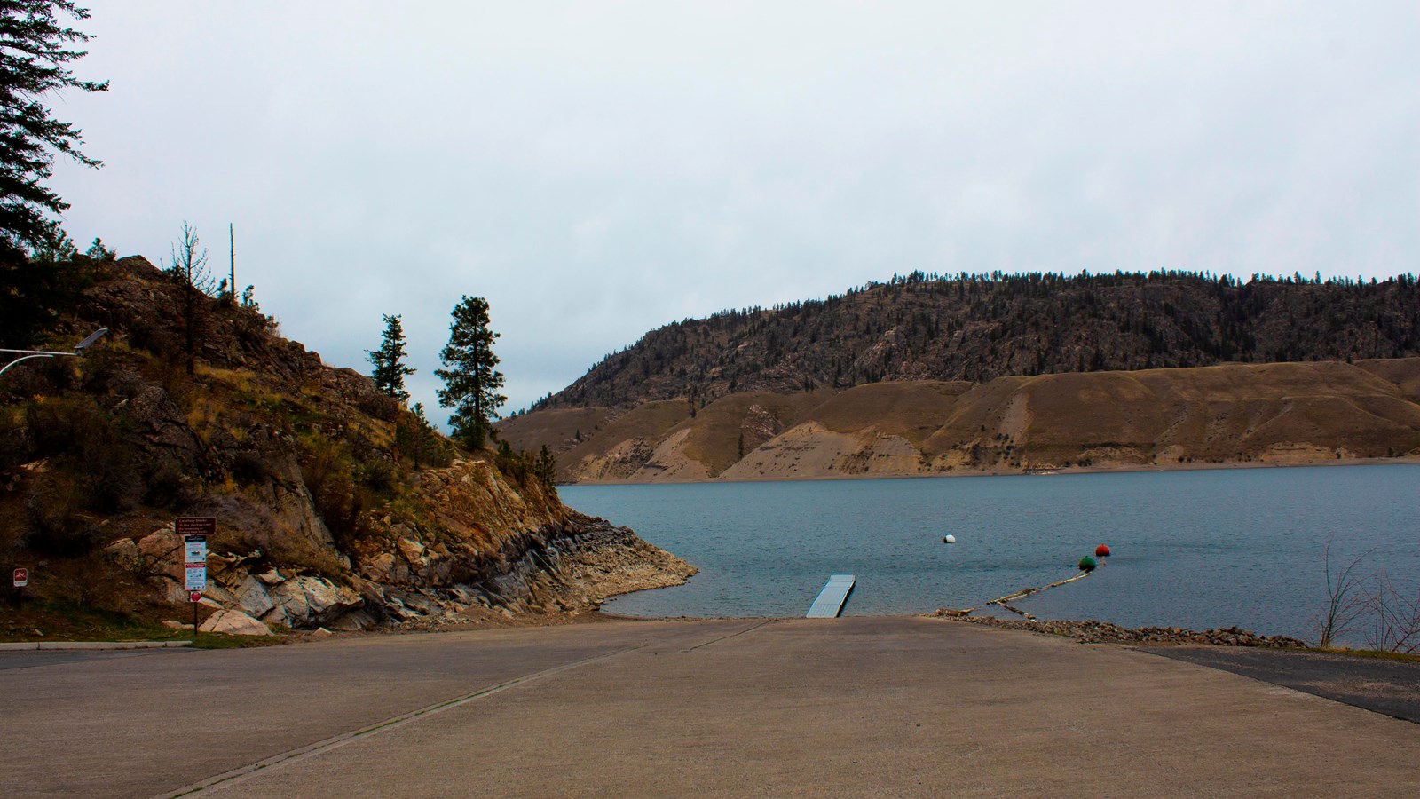 A paved boat launch with a floating dock.