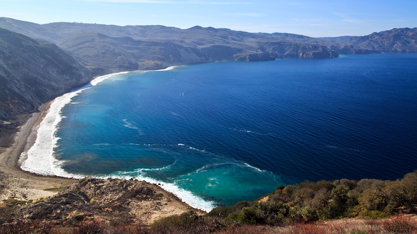 Large harbor on the northern side of Santa Cruz Island that is surrounded by steep hillsides.