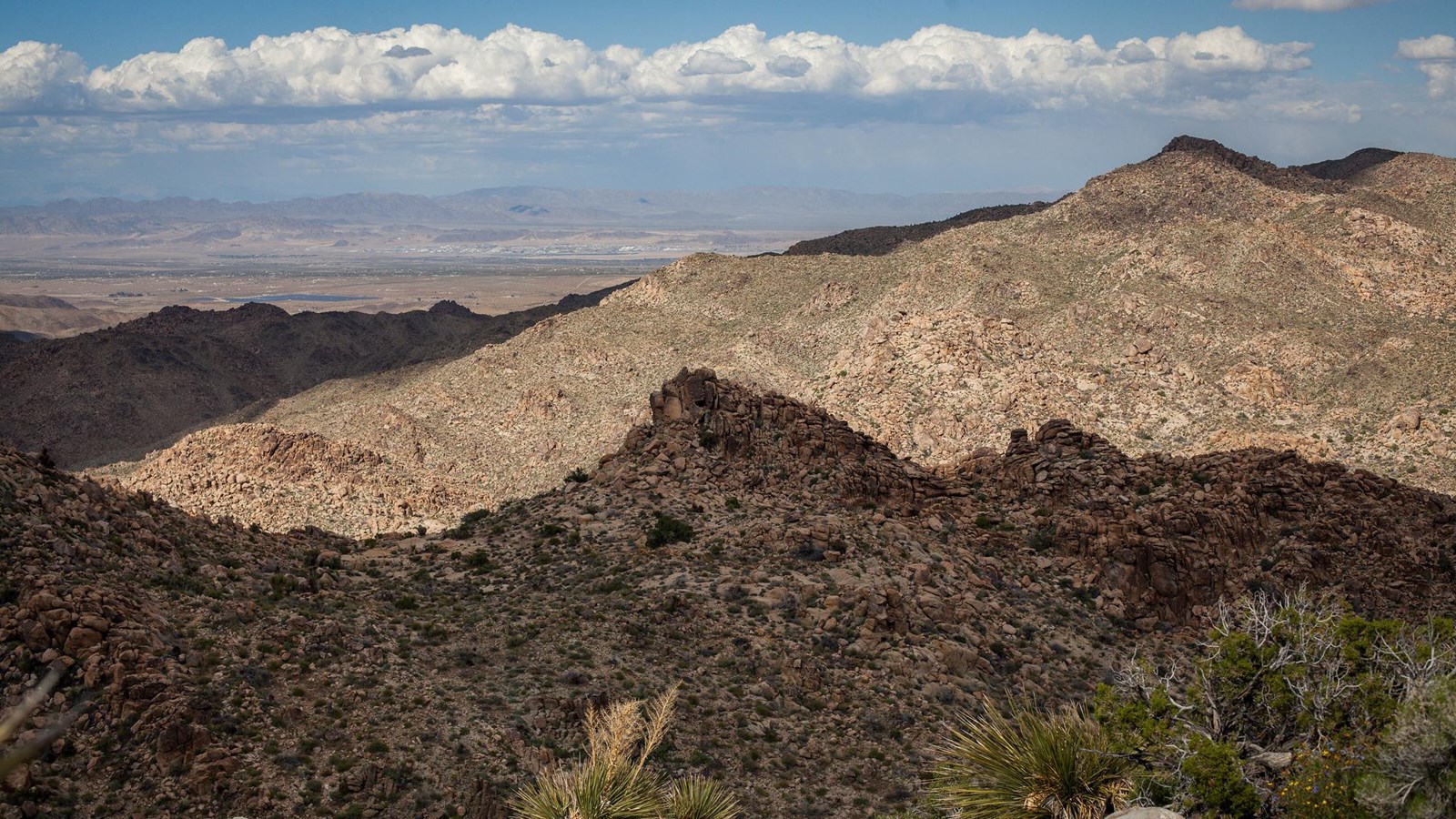 A rocky mountainous landscape with shadows cast from mountains out of view. 
