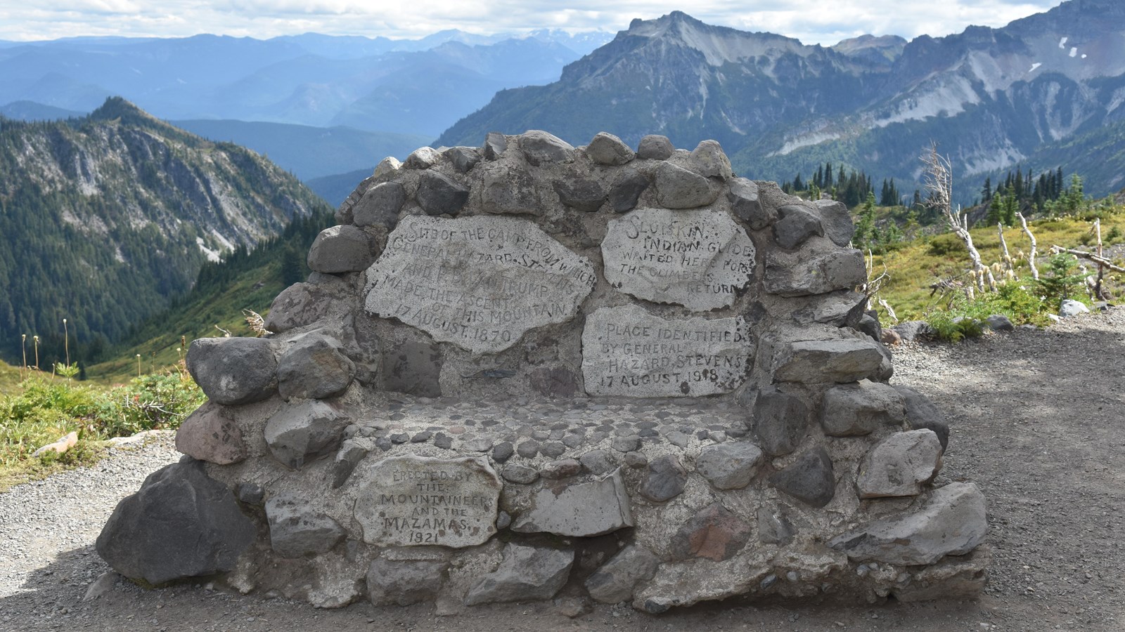 Rocky stone bench with inscriptions located in a meadow