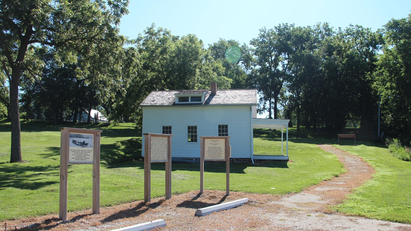 The corner of a gravel parking area is at the lower quarter of the image.