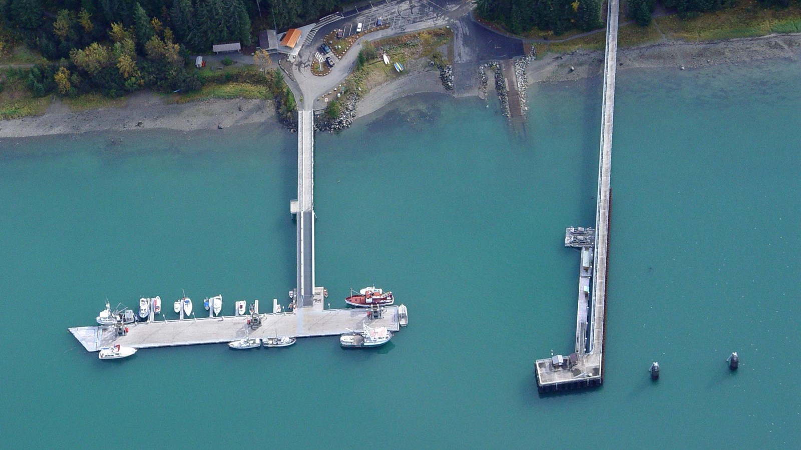 Aerial view of a public dock and fuel dock jutting out from the coastline