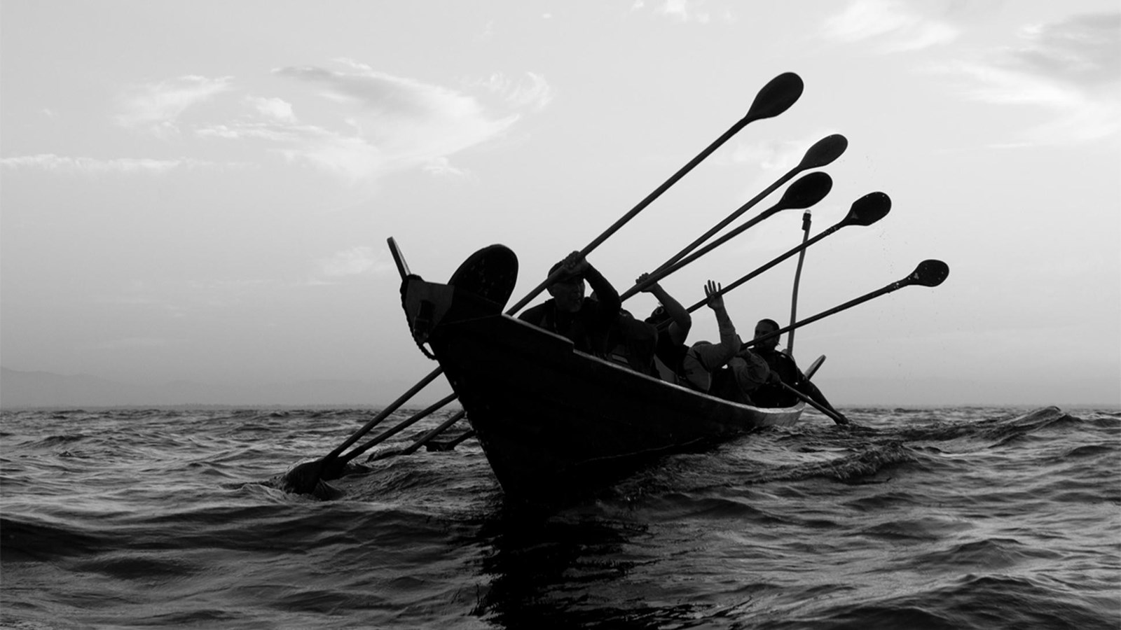 canoe being paddled over ocean
