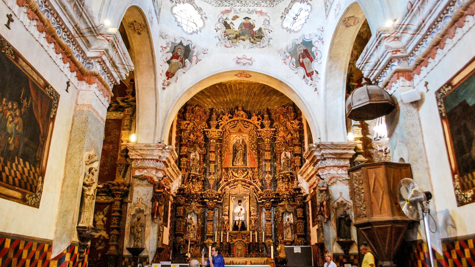 The elaborate, multi-colored, baroque alter inside a mission church