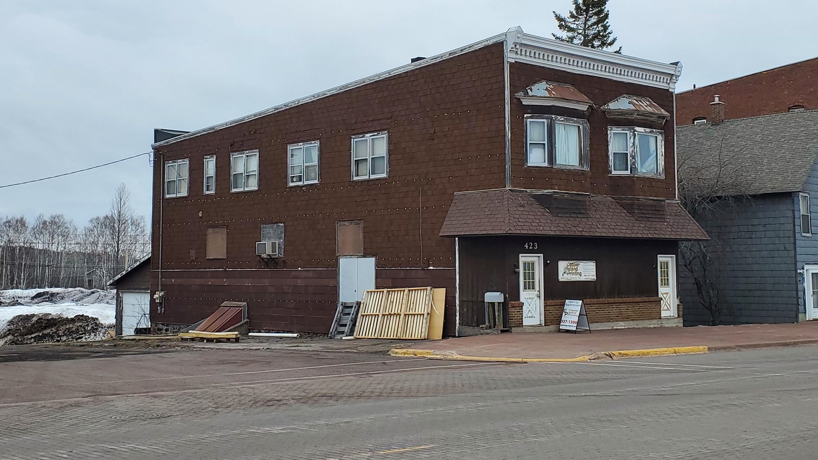 Two story wood-frame building with flat roof.
