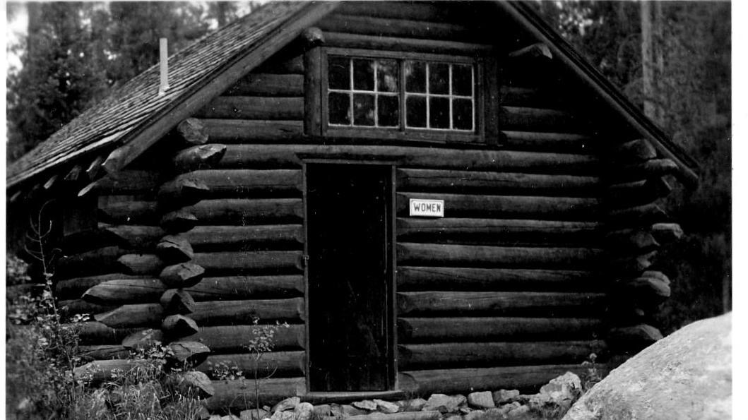 A historic black and white photo of the first park restroom now located in the Jenny Lake Campground