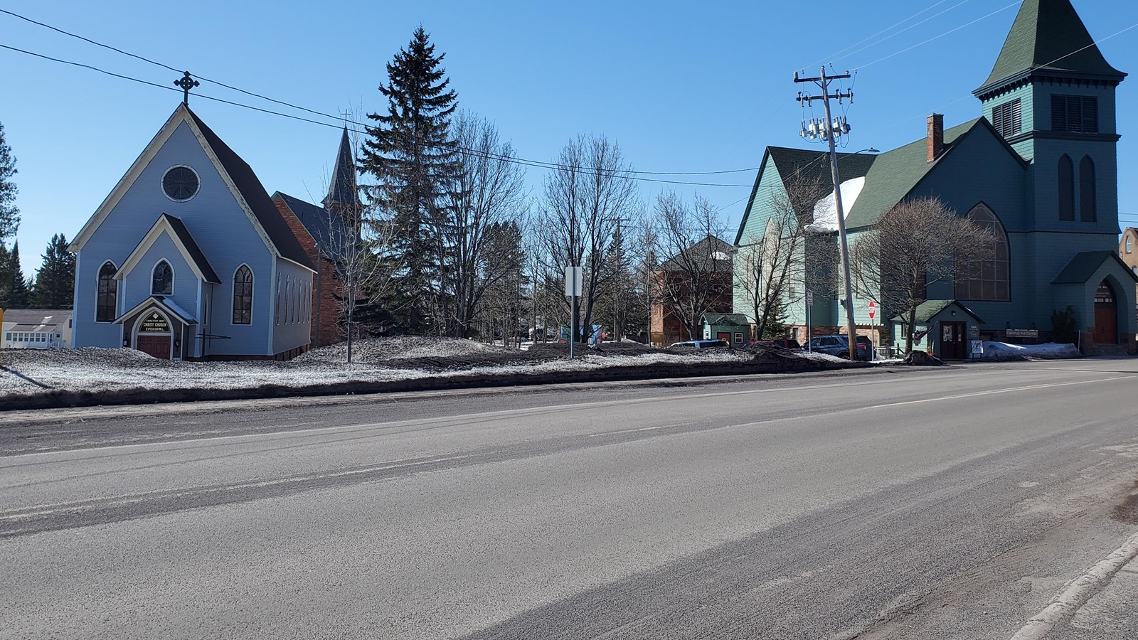 Winter scene of three churches with road in the foreground