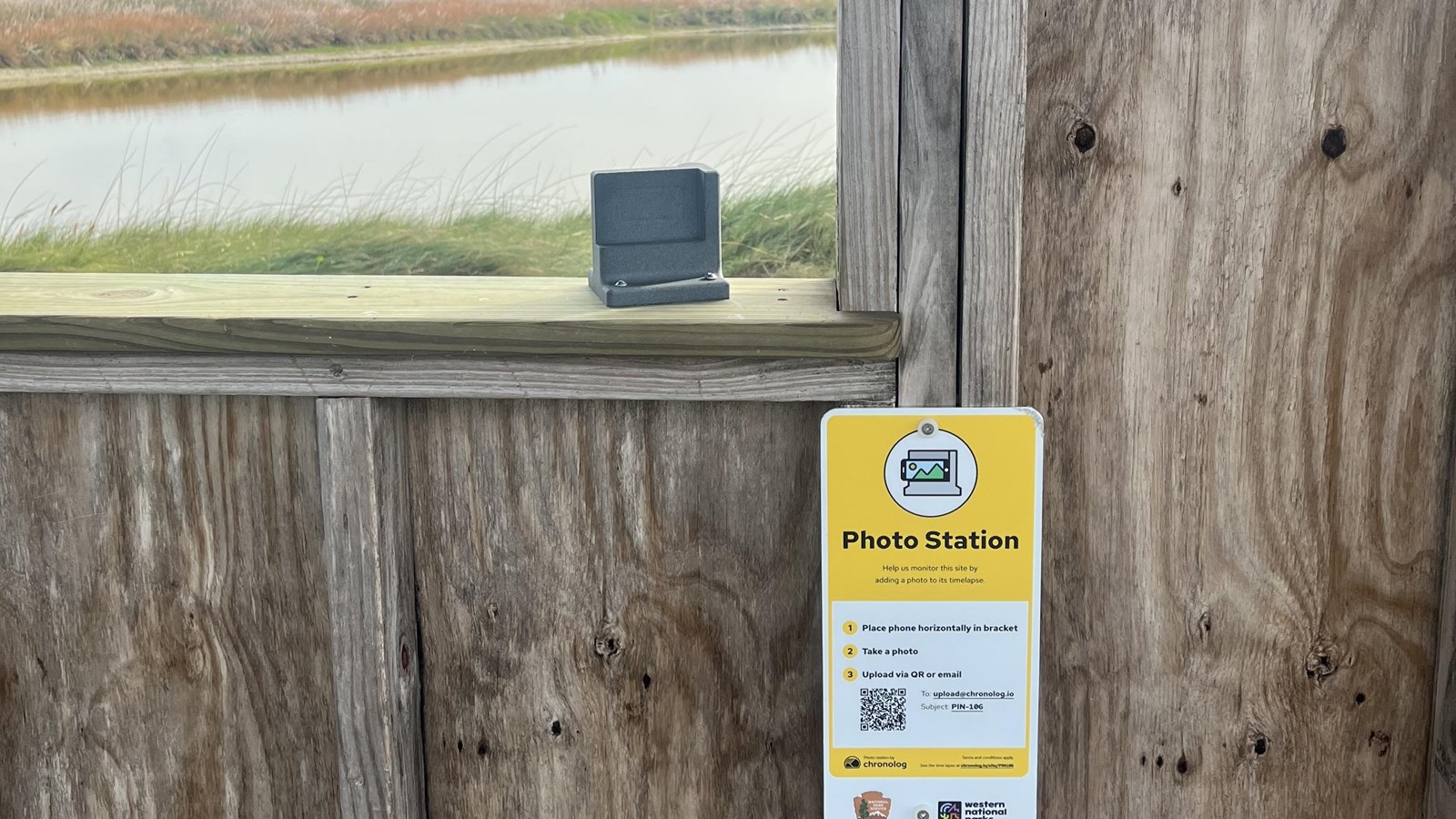 A photo station attached to a wooden strucutre.