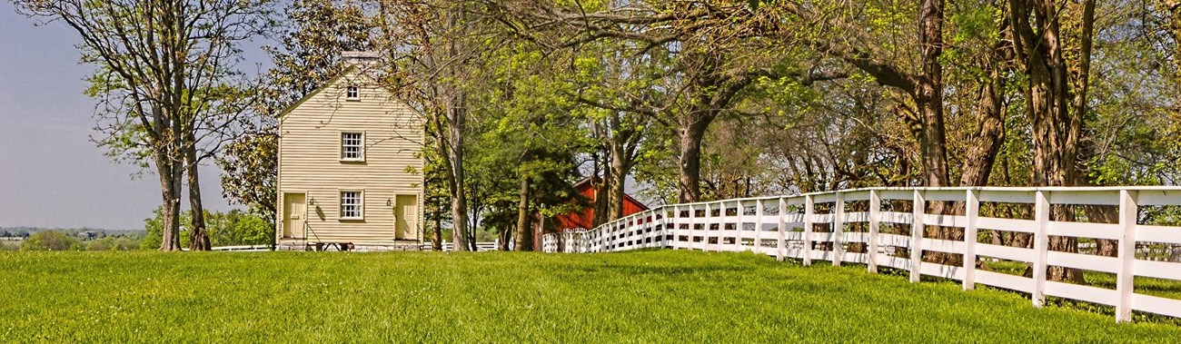 fence leading to a simple clapboard building