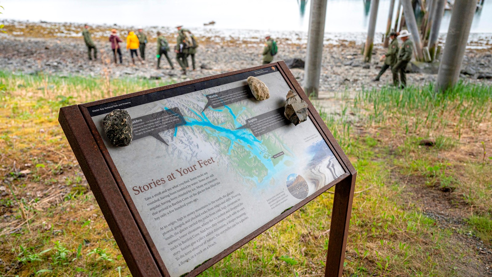 A wayside sign shows info about geology in Bartlett Cove.