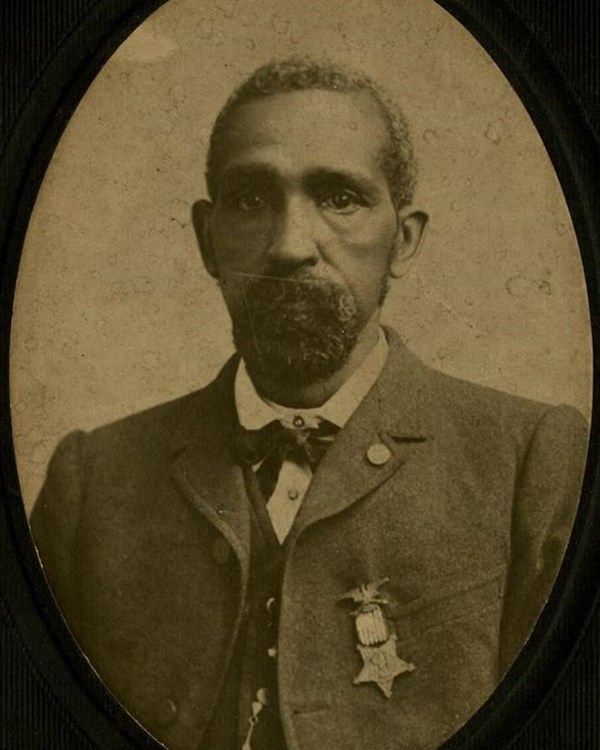 Black and White photo of African American man from the chest up.