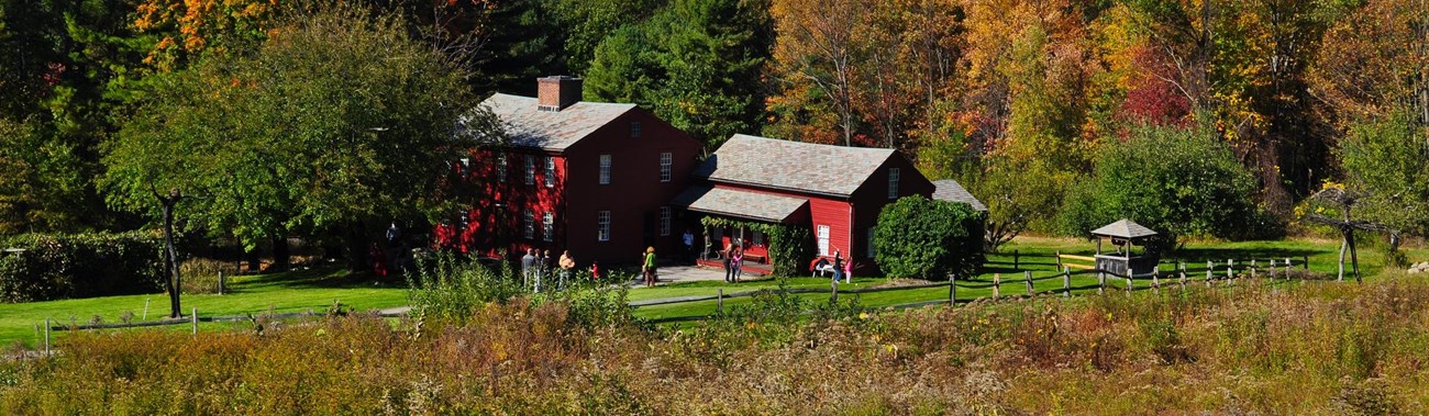 red clapboard buildings in a rural setting