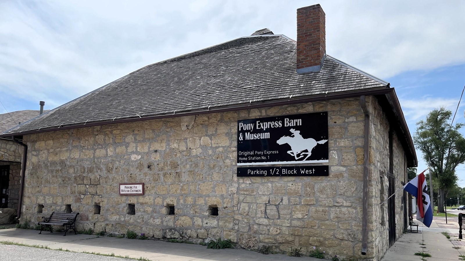 A stone, one-story building, with a wooden front door and no windows.
