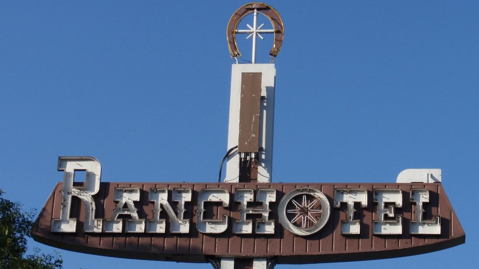 A brown sign with white text that reads 