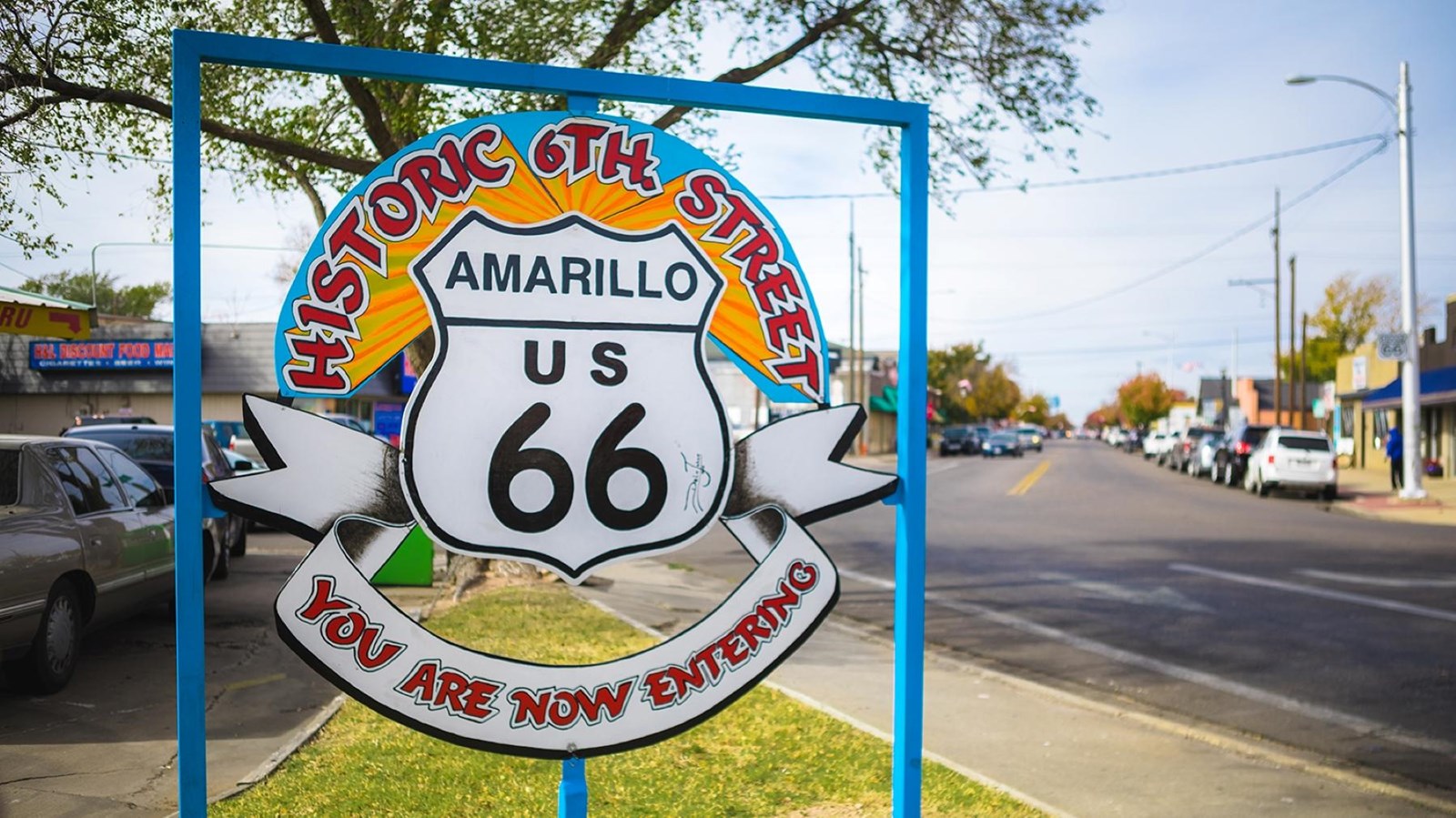 A blue, yellow, white, red sign reads 