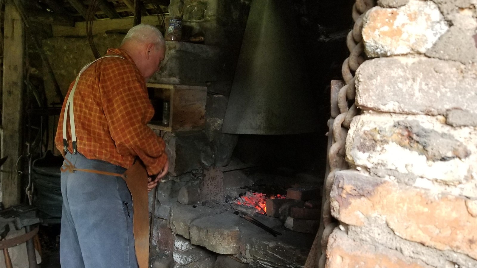Blacksmith at work near firey forge