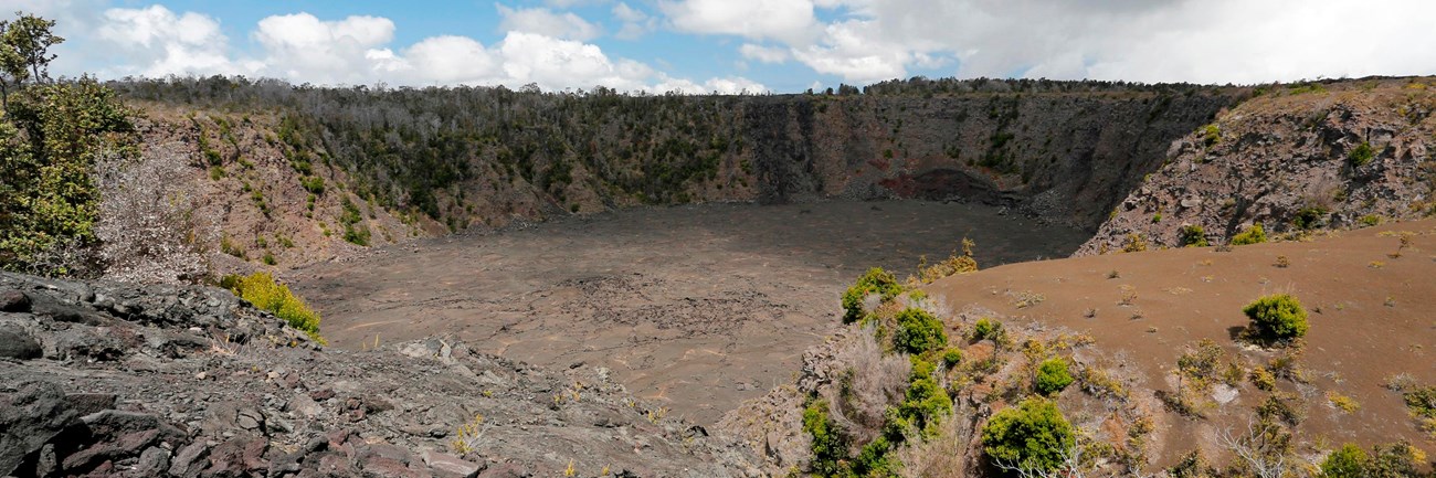 Pit crater with stone wall in the foreground