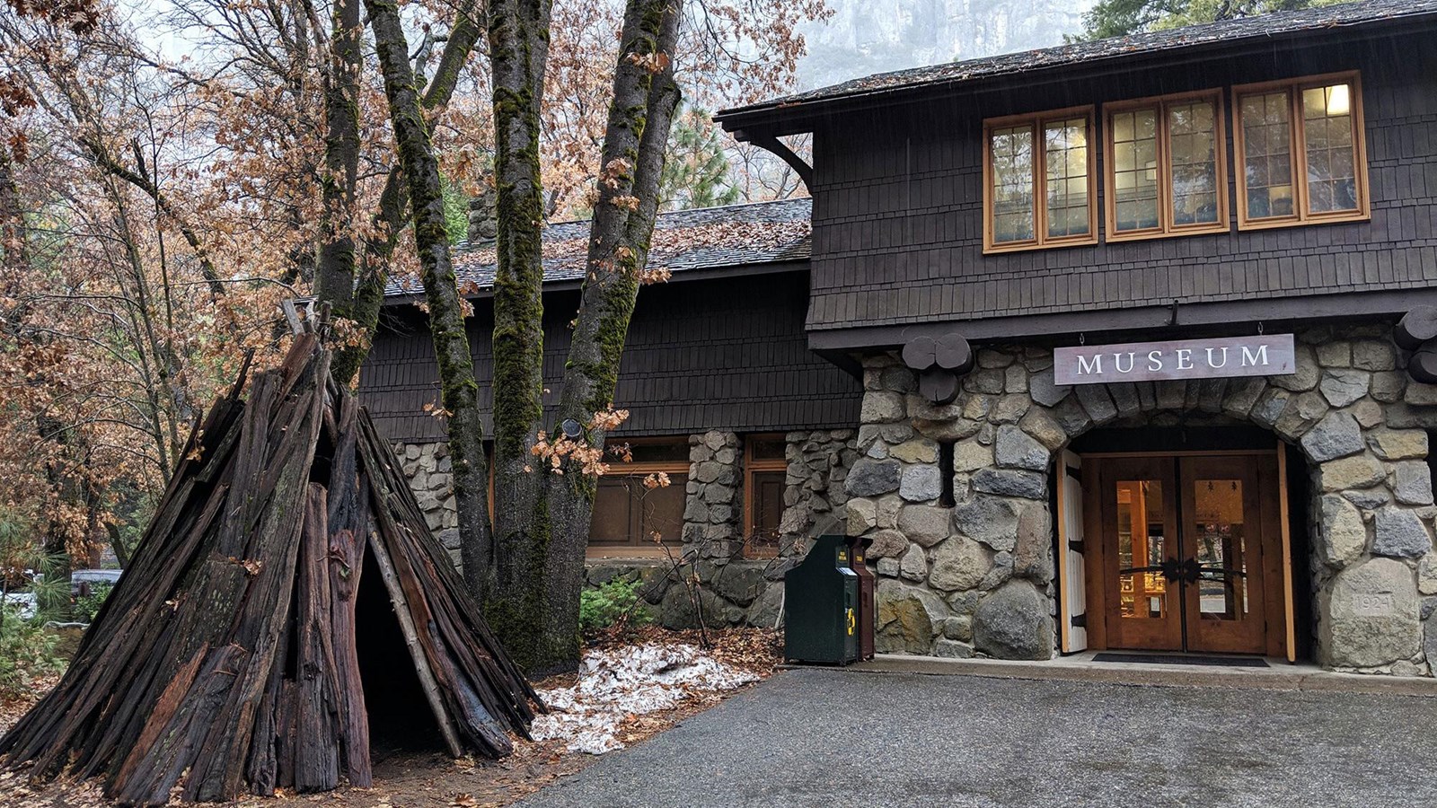 Yosemite Museum building with wood bark house to the left of the main door