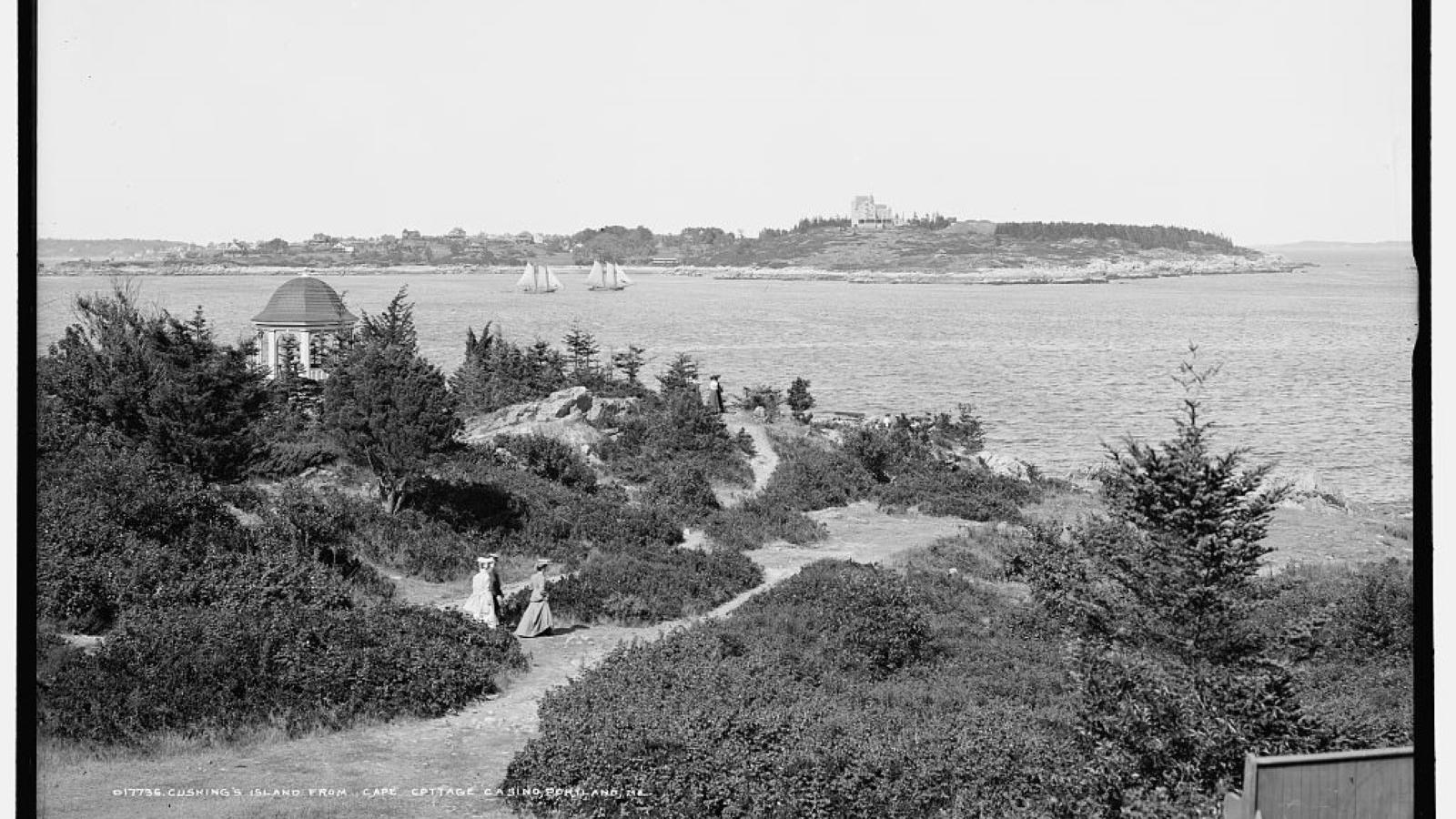 People walking along dirt path to beach