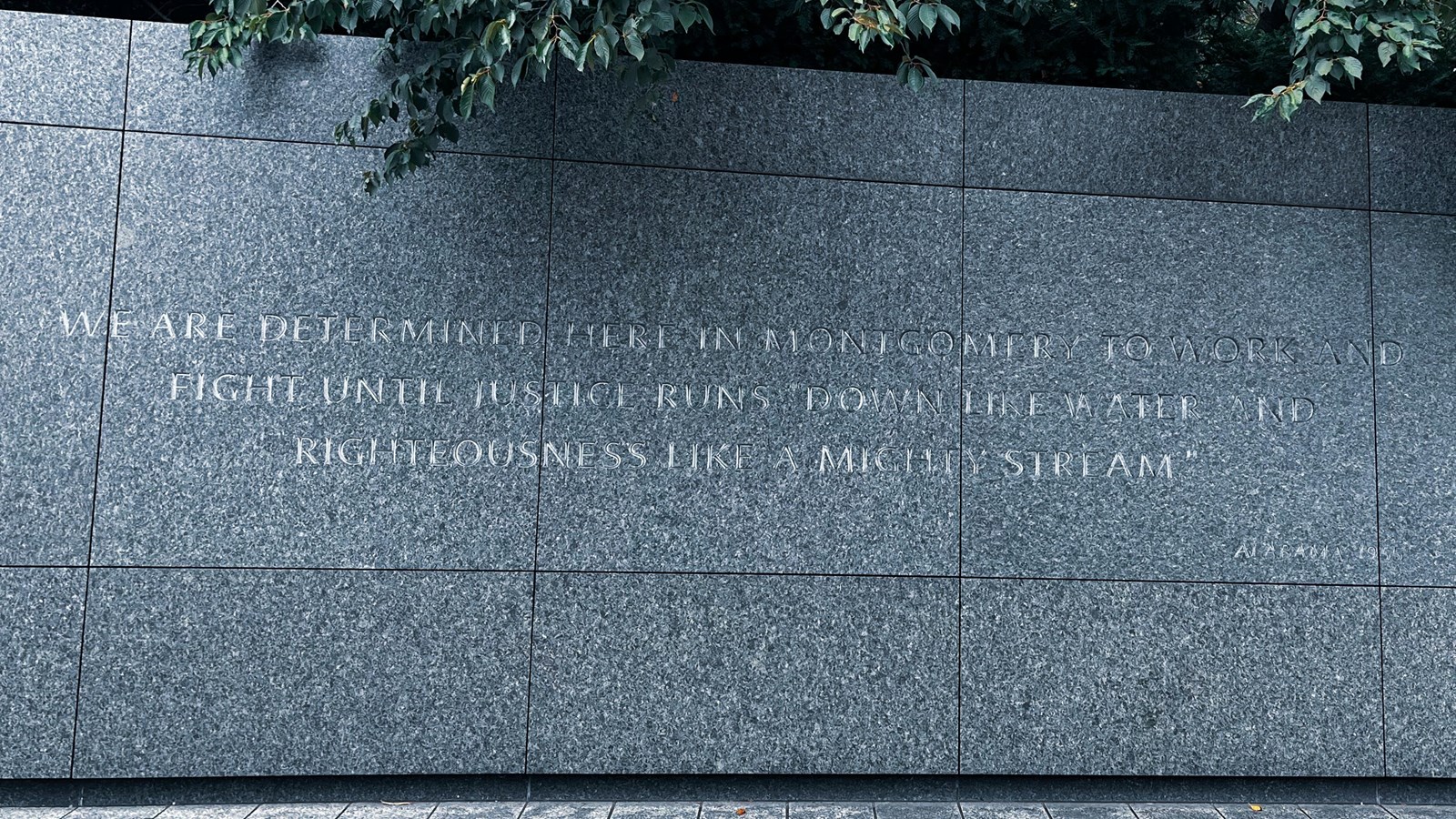 Dark Stone Wall with quotation etched into it