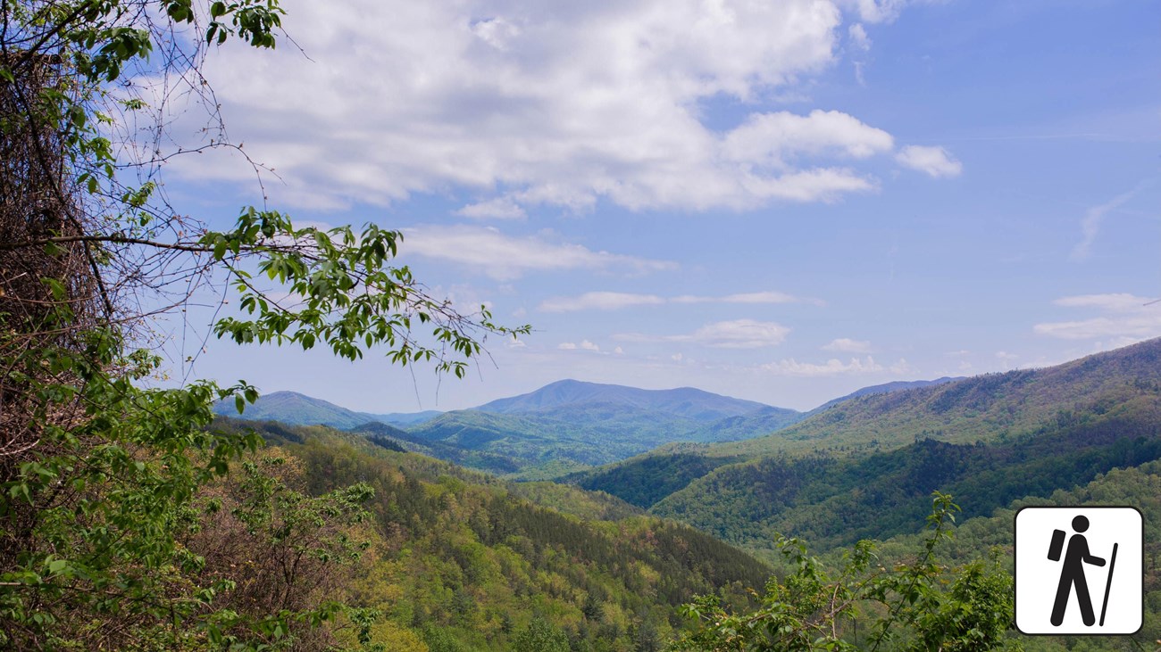 A vast mountain view. Hiker icon in lower right corner.