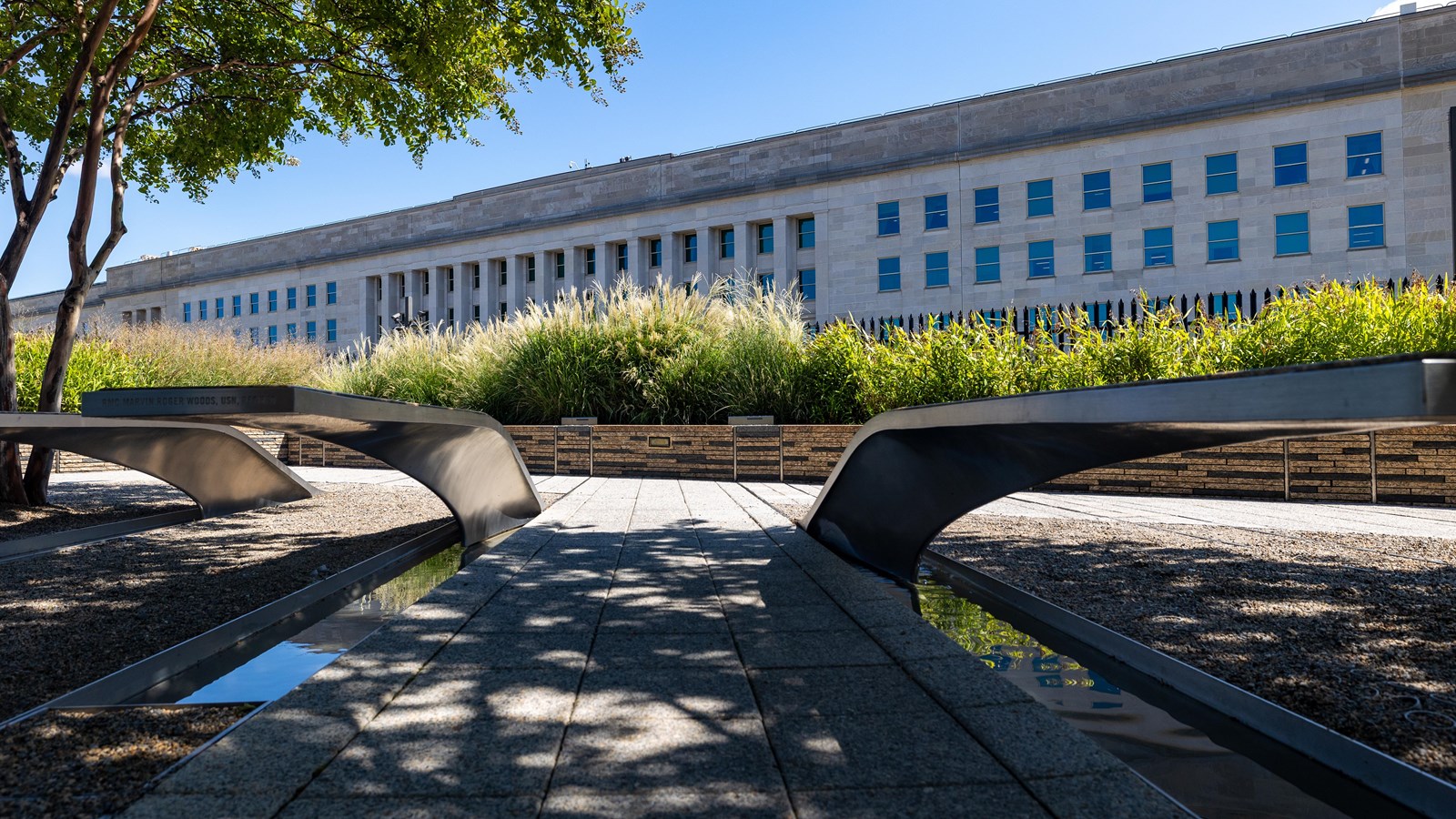 Two shaded benches in front of the Pentagon building.