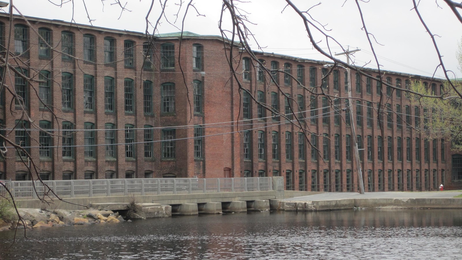 Large red brick building with water in the foreground