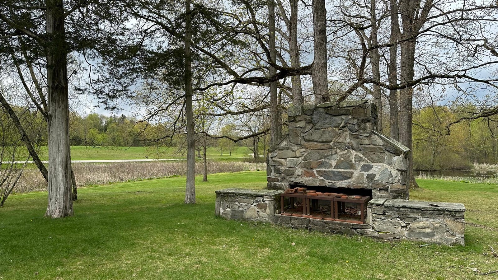 A large fieldstone fireplace with chimney.