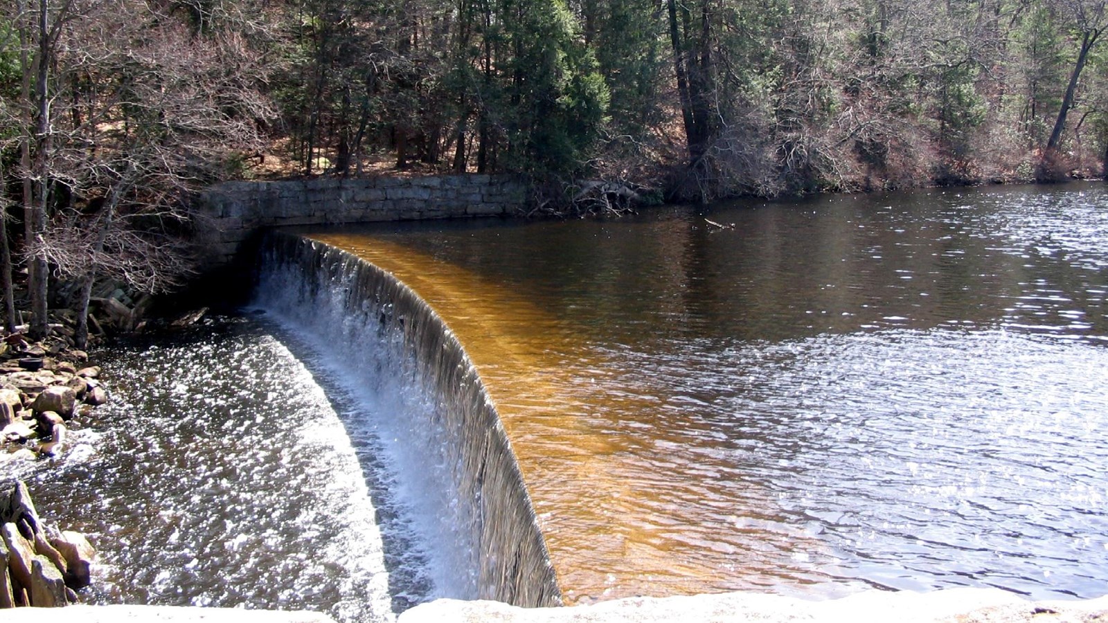 Dam producing a waterfall along the branch river