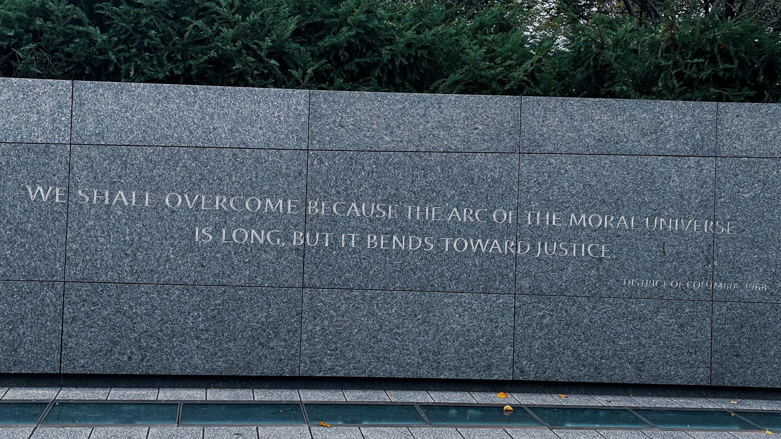 Dark stone wall with letters etched into it