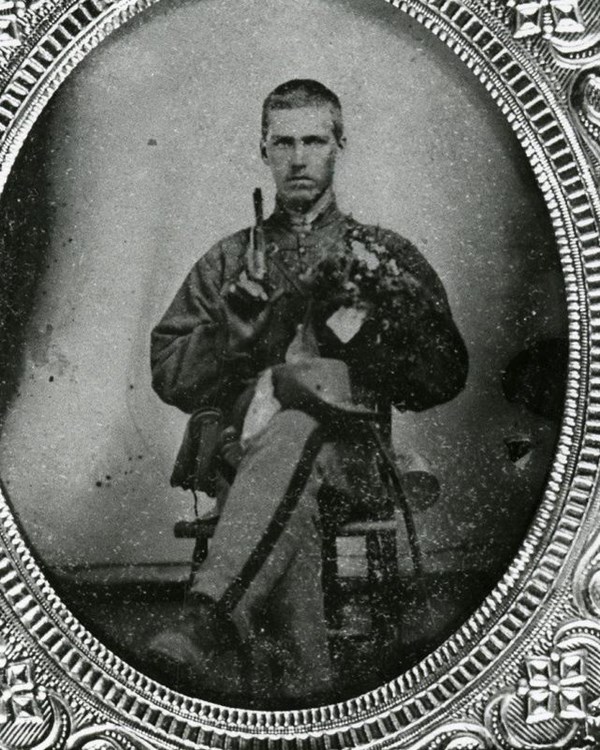 Man sitting wearing a Confederate uniform