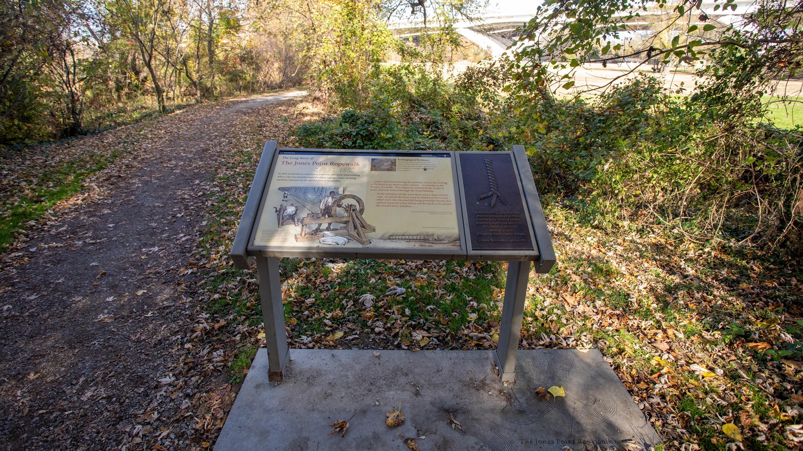An information panel with an image of men making rope with a large wheel and spool.