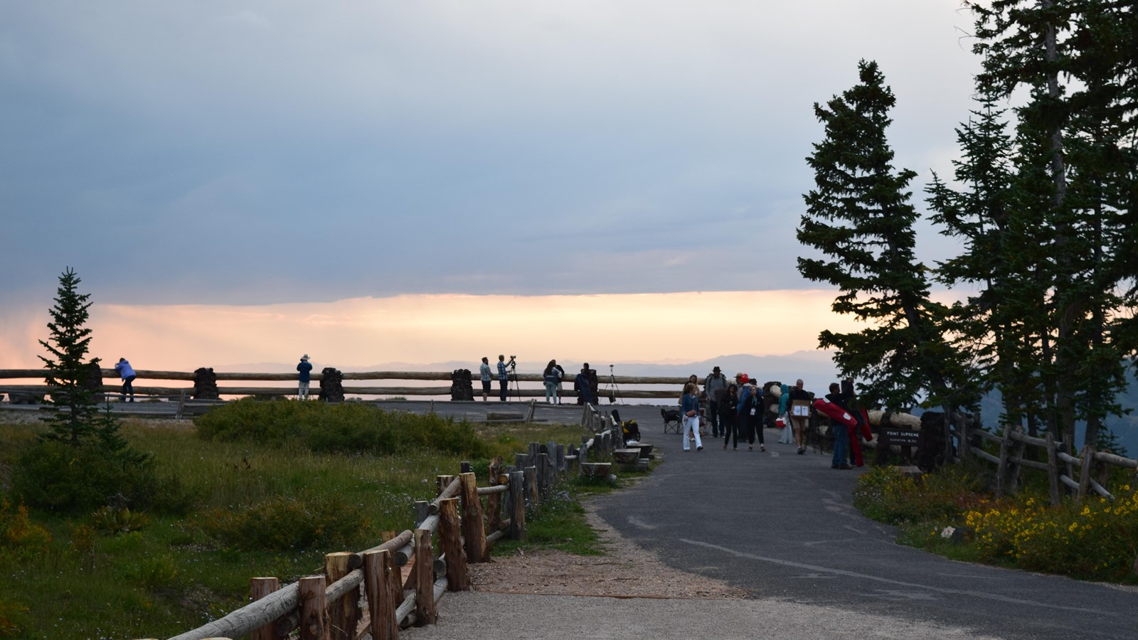 A paved path extends away from the camera leading to an overlook.