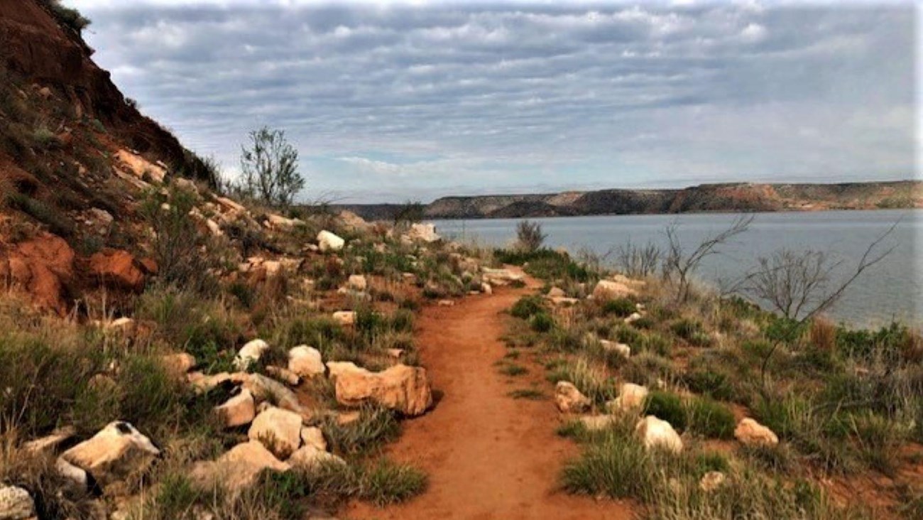 A trail running along the shoreline of Lake Meredith.  The lake is in the background.