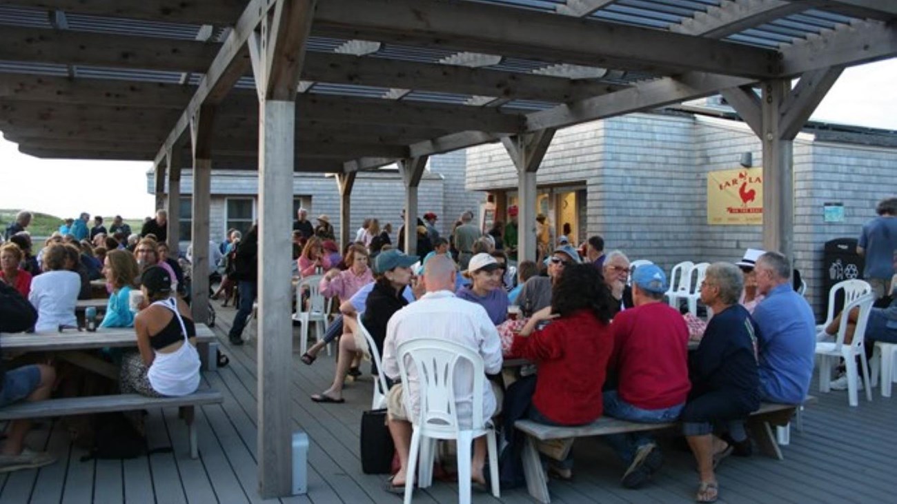 Visitors enjoy food at the snack shack on a summer day.