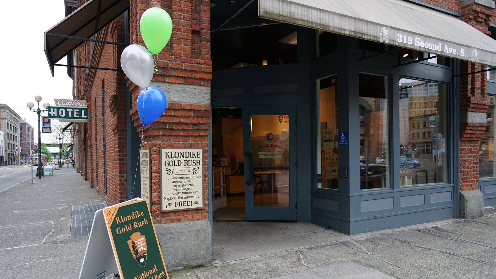 Entrance to the Klondike Gold Rush National Historical Park, located on a bustling city street. 