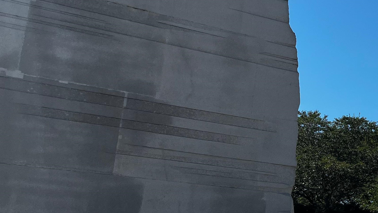 Tall white stone with striations running from top to bottom