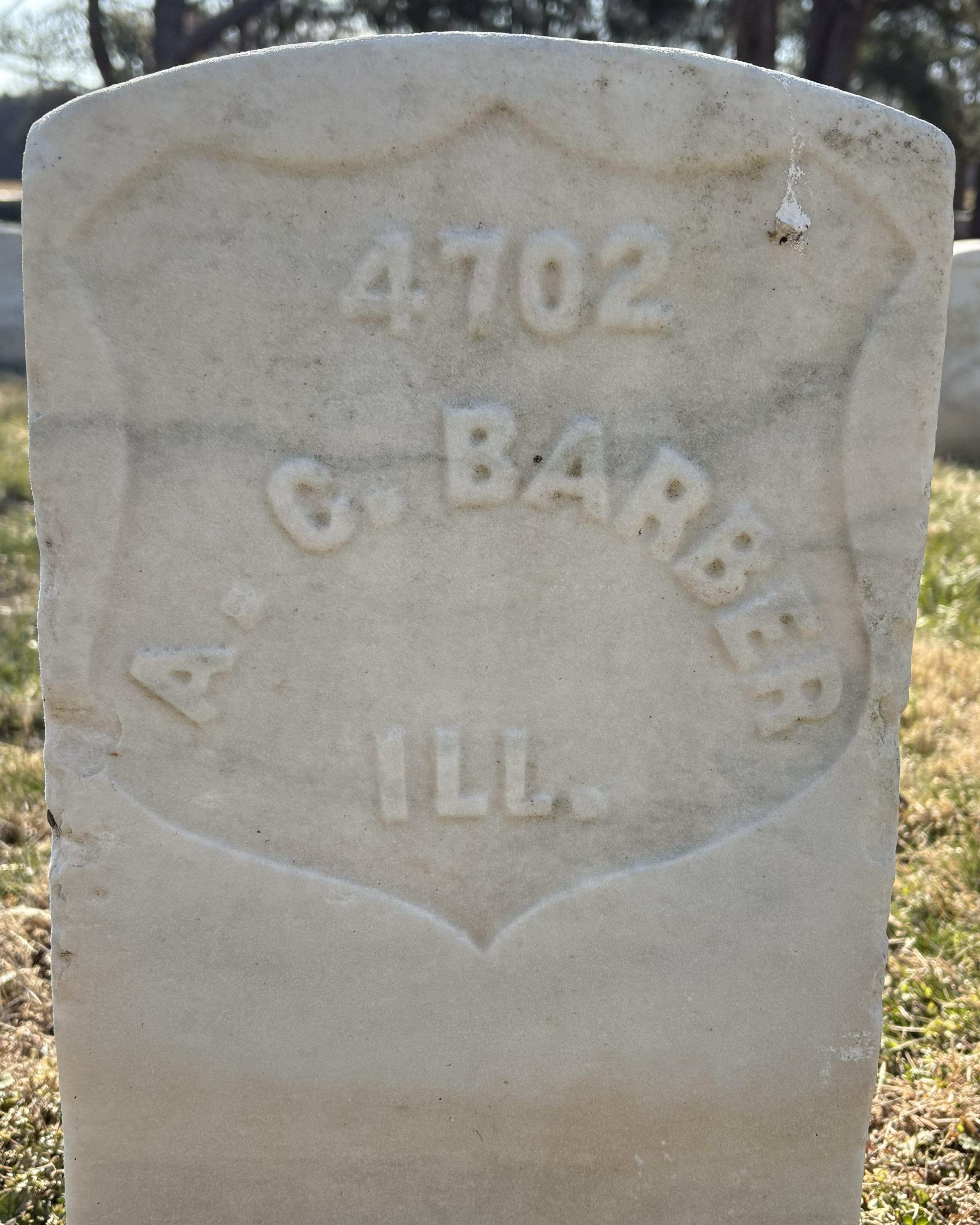 Marble headstone with the name "A C Barber" on it. 