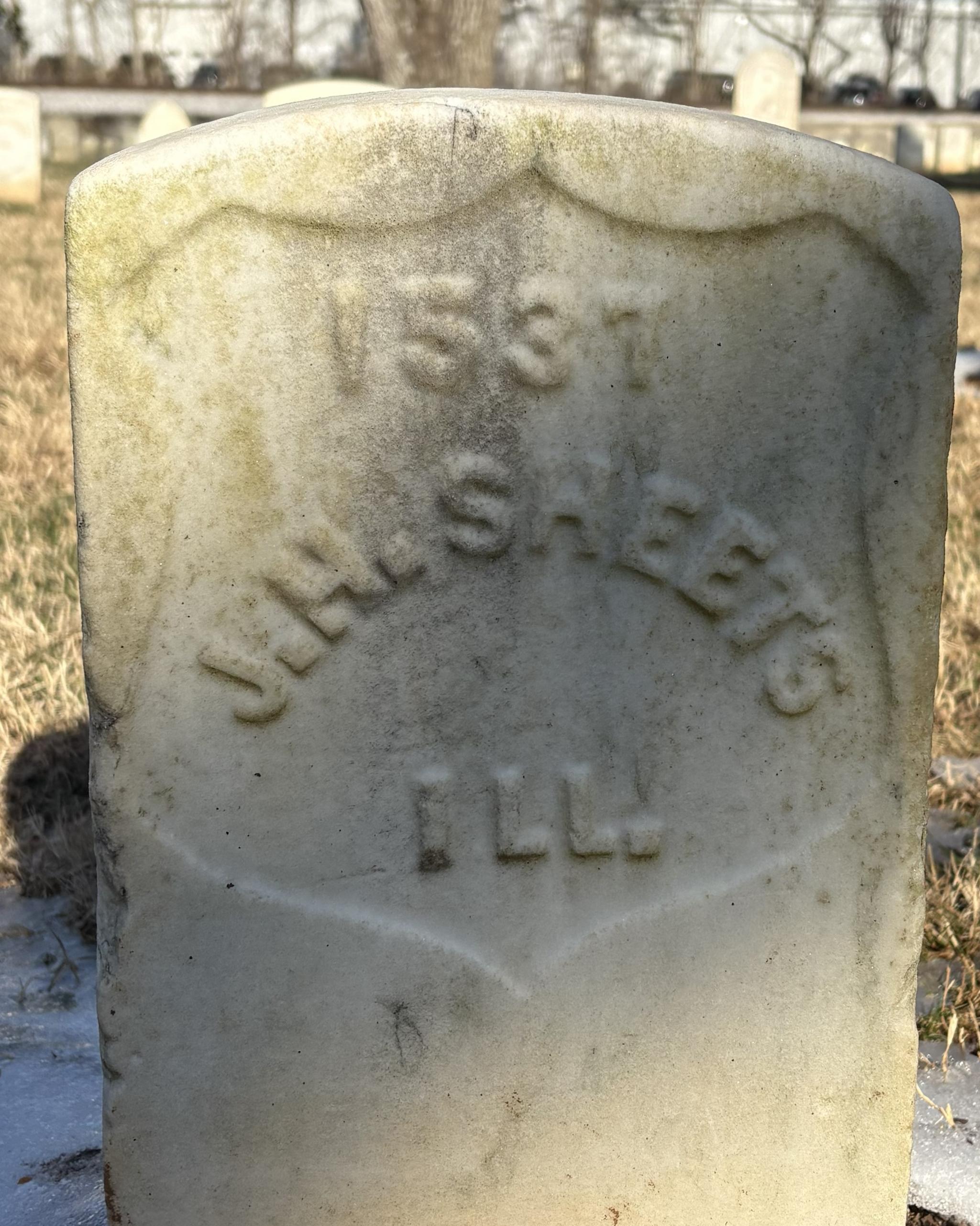 Marble headstone with the name "J H Sheets."