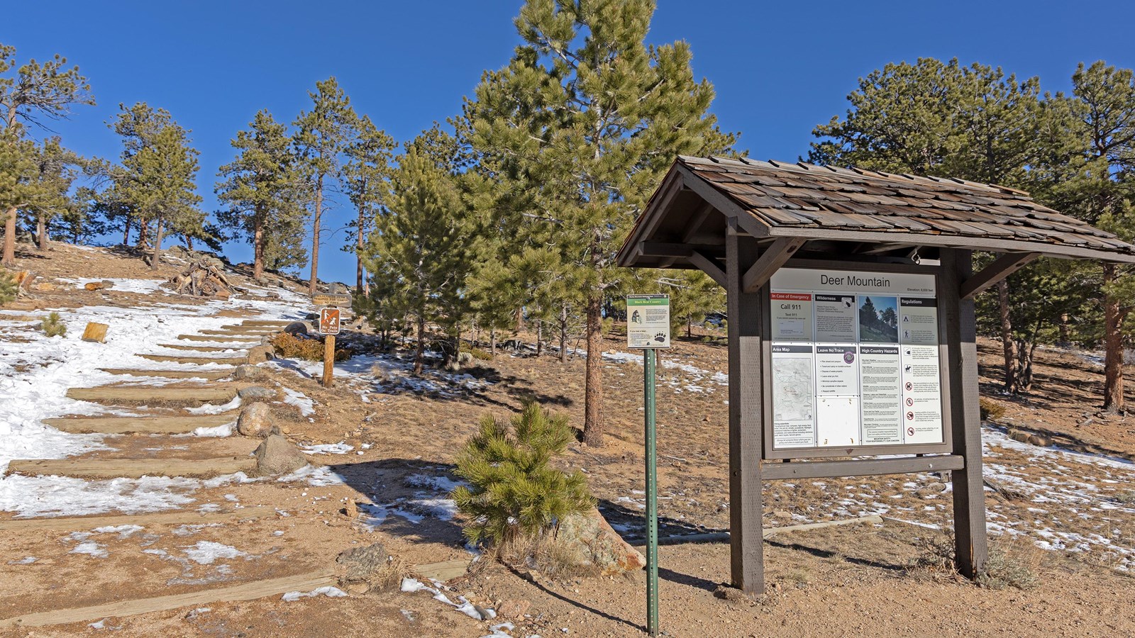 Patchy snow and ice is on the ground on the trail to Deer Mountain 