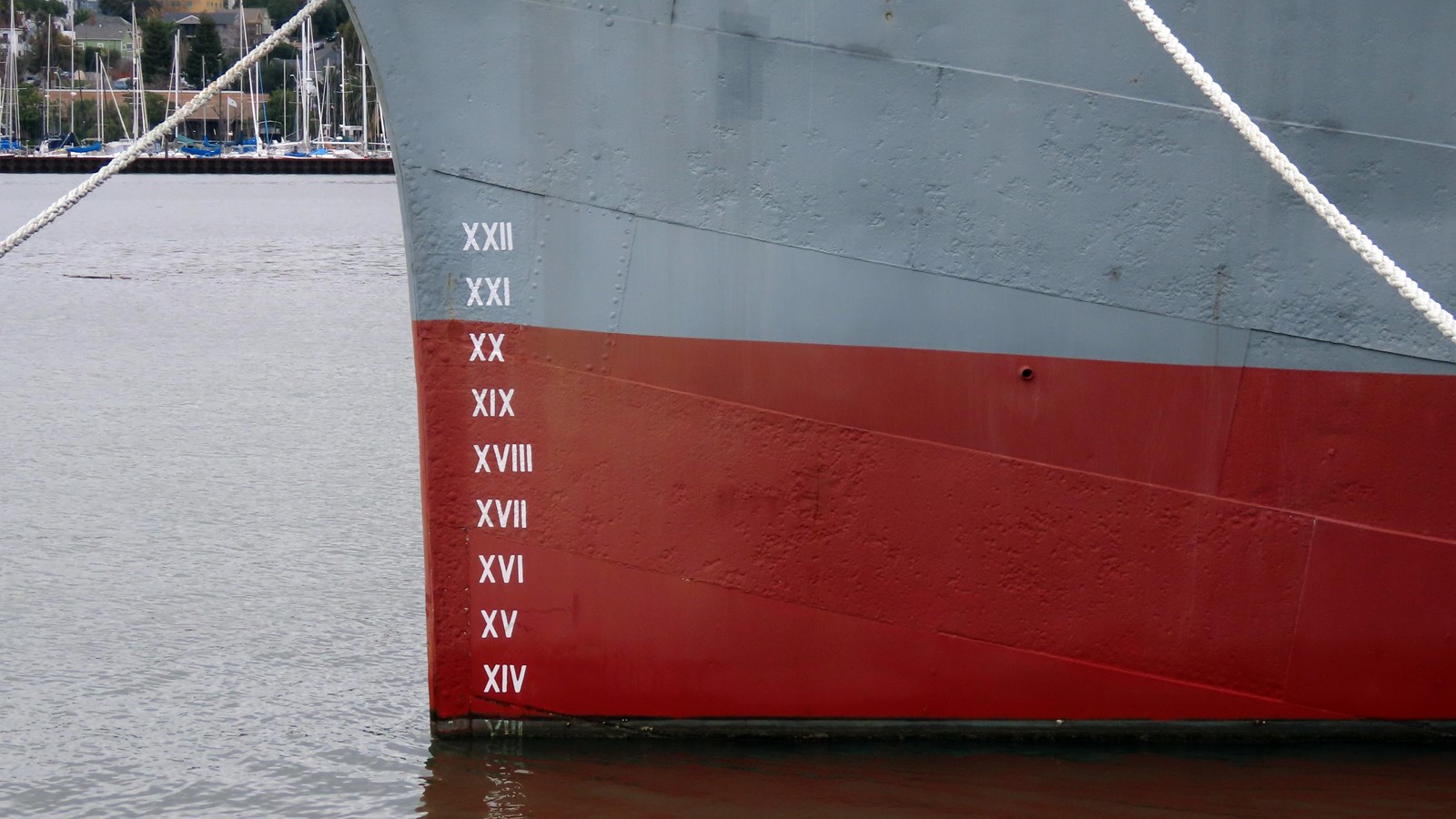 A column of roman numerals painted in white on the hull of Balclutha.
