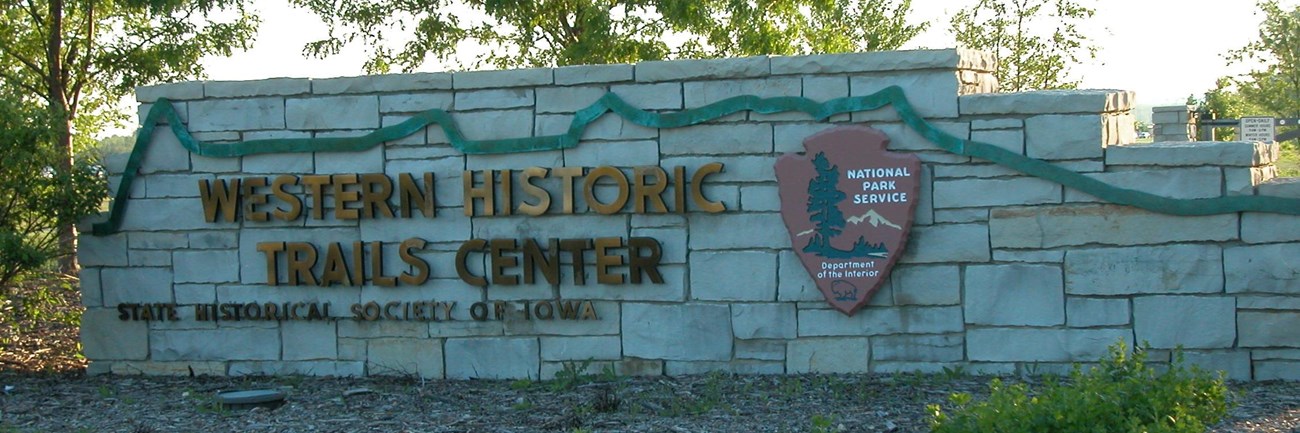 A stone entry way sign to the western historic trails center.